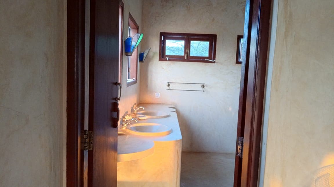 Modern bathroom sink area in Little Nyumba Ya Mwezi